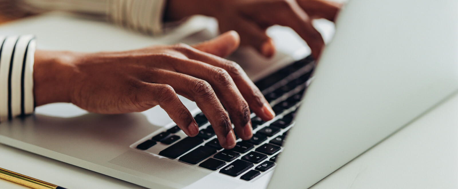 Hands typing on keyboard