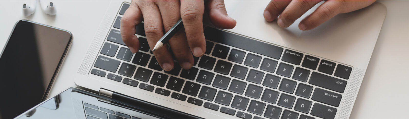 Hands typing on laptop